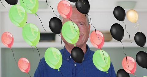Senior Man Celebrating with Colorful Balloons Indoors - Download Free Stock Images Pikwizard.com