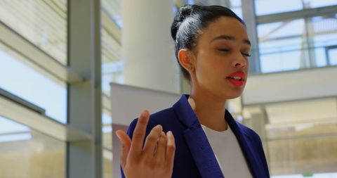 Young Professional Female Speaks Confidently at Business Event