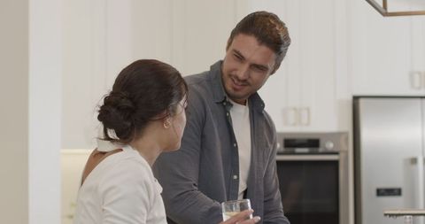 Couple Engaging While Cooking in Modern Kitchen Setting
