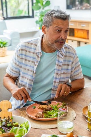 Senior Man Enjoying Healthy Meal at Home Dining Table