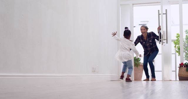 Happy Grandmother Greeting Excited Granddaughter at Front Door - Download Free Stock Images Pikwizard.com