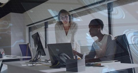 Two Professional Women Collaborating in Modern Workplace