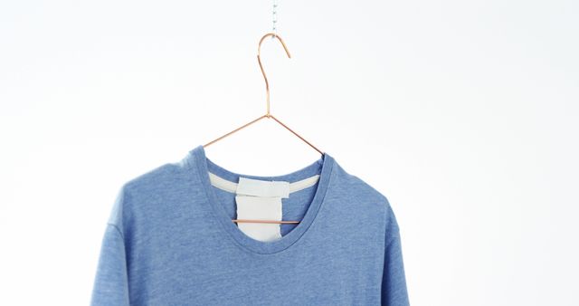 Blue T-Shirt Hanging on Simple Wire Hanger - Download Free Stock Images Pikwizard.com