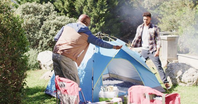 Father and Son Setting Up Tent on Grass during Daytime - Download Free Stock Images Pikwizard.com