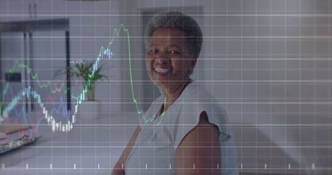Senior woman analyzing graph data in modern home office