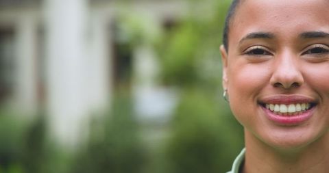 Smiling Woman Enjoying Outdoors in Tranquil Garden