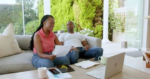 Couple Collaborating on Finances with Digital Devices