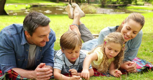 Happy Family Relaxing on Grass in Park - Download Free Stock Images Pikwizard.com