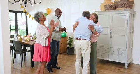 Joyful Senior Friends Celebrating Birthday in Cozy Living Room