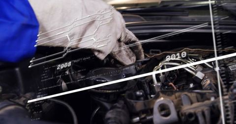 Mechanic inspecting engine bay with digital diagnostics overlay for automotive maintenance