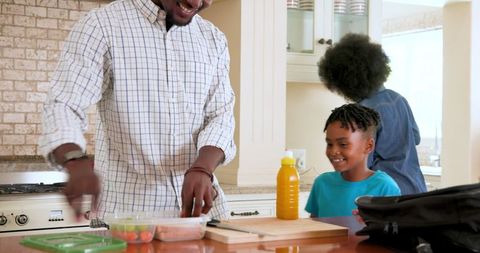 Family Preparing Lunch for School at Home