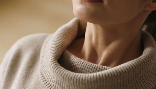 Cozy beige ribbed cowl neck sweater showcasing elegant neck lines and soft knit texture