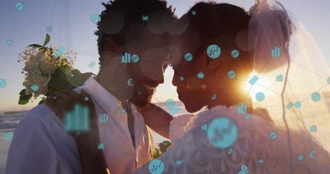 Sunset wedding couple embracing on beach with digital finance overlay silhouette veil