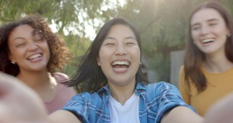 Joyful Women Friends Taking Selfie in Sunlit Backyard
