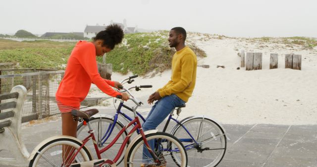 Young Couple Enjoying Casual Bike Ride on Beach Boardwalk - Download Free Stock Images Pikwizard.com