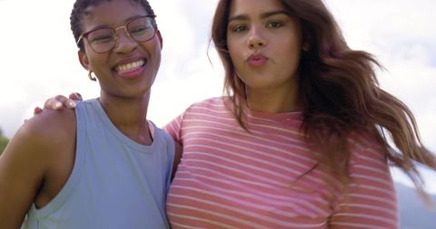 African american women friends smiling and puckering lips outdoors lifestyle portrait