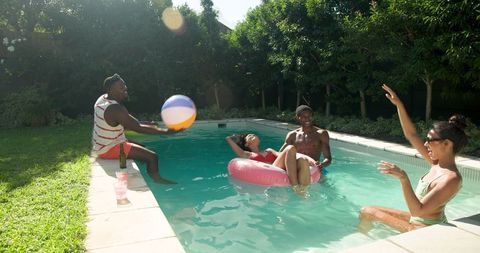 Diverse Friends Enjoying Sunny Day at Backyard Pool