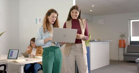 Women professionals collaborating in modern office setting