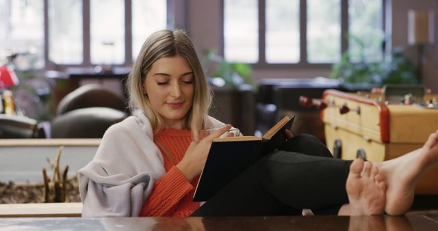 Young Woman Relaxing at Home Reading Book on Cozy Couch - Download Free Stock Images Pikwizard.com