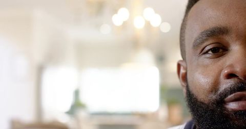 Half Face African American Man with Beard in Cozy Living Room