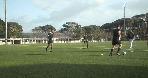 Youth soccer players practicing on field focus on teamwork and skills