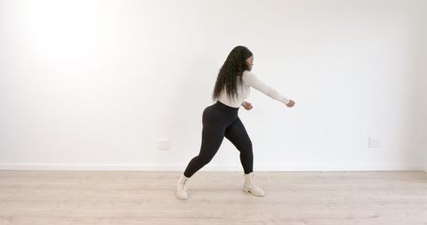 Energetic Dance Movement by Woman in Bright Modern Space