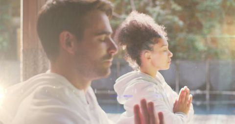 Diverse Individuals Meditating Outdoors on Bright Day