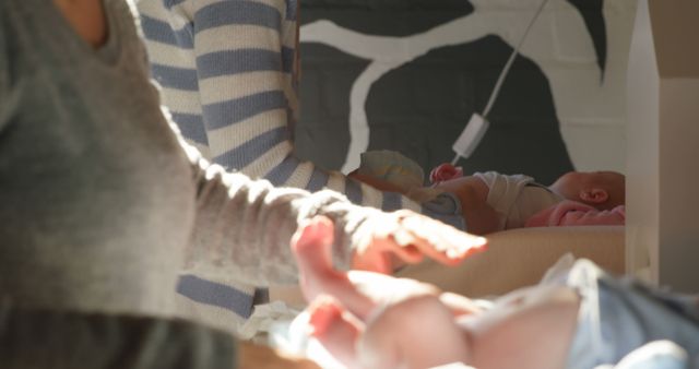 Parents Changing Diapers on Newborn Infants in Nursery - Download Free Stock Images Pikwizard.com