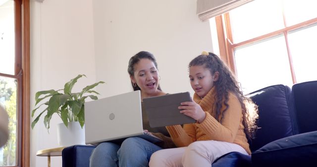 Mother and Daughter Using Laptop and Tablet in Cozy Living Room - Download Free Stock Images Pikwizard.com