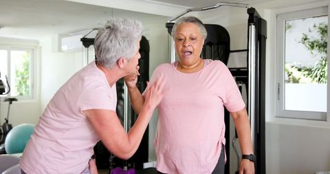 Senior lesbian couple enjoying home workout exercise