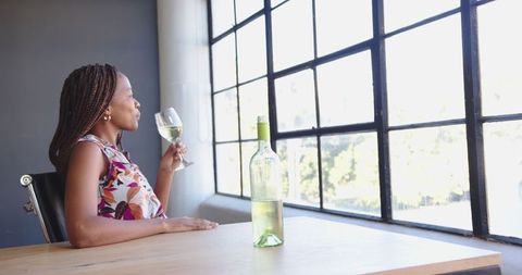 Businesswoman Resting with White Wine by Sunlit Window - Download Free Stock Images Pikwizard.com