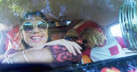 Happy Friends Enjoying Road Trip in Retro Van
