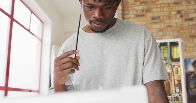 Focused Young Male Artist Reflecting While Painting in Studio - Download Free Stock Images Pikwizard.com