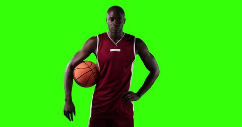 Confident african american basketball player posing with ball