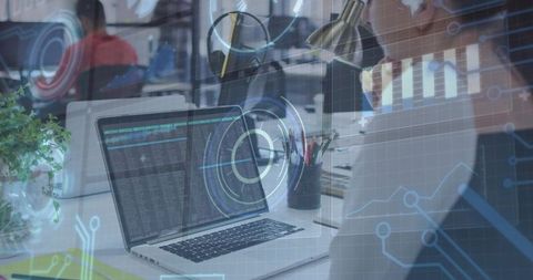 Developer Working with Code and Futuristic HUD Overlays on Laptop in Open Office