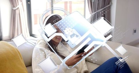 Young woman relaxing on sofa using smartphone with headset and augmented reality ui