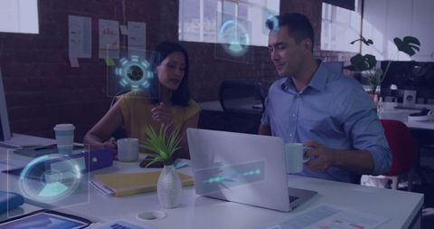 Colleagues Discussing Analytics in Modern Office with Laptop