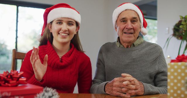 Happy caucasian senior father and adult daughter wearing santa hats making image call at home - Download Free Stock Photos Pikwizard.com