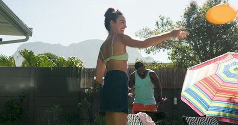 Friends Enjoying Outdoor Frisbee and Barbecue