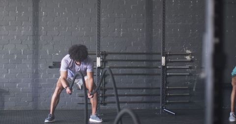 Man Taking a Break from Fitness Workout in Gym