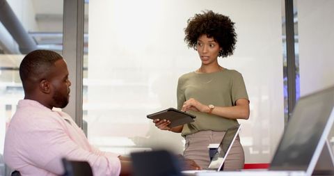 Coworkers Collaborating with Tablet Technology in Modern Office