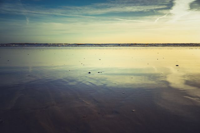 Serene Beach Sunset with Reflective Wet Sand - Download Free Stock Photos Pikwizard.com