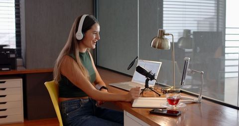 Female Podcaster Recording in Modern Studio with Efficient Setup