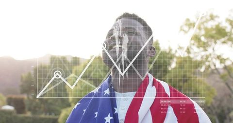 Patriotic man wrapped in USA flag contemplating future with financial graph overlay