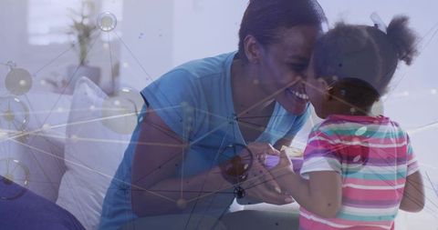 Mother and daughter sharing forehead touch smiling, bonding at home amid network overlay