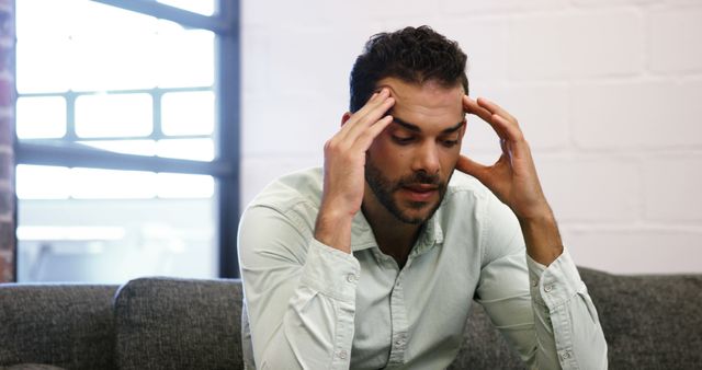 Stressed Man Sitting on Sofa in Modern Office - Download Free Stock Images Pikwizard.com