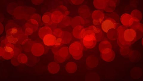 Glowing red bokeh background with layered translucent discs and soft burgundy radial glow