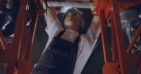 Mechanic Under Vehicle Performing Electrical Repairs