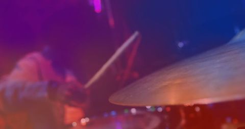 Colorful lights enhancing energetic drummer performance