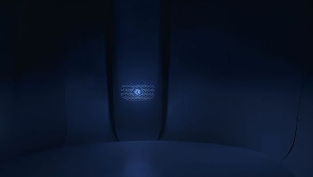 Futuristic navy-blue pod interior featuring glowing hexagonal mesh grille